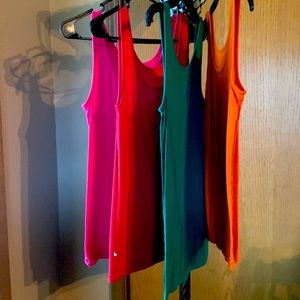 Set of four long tanks. Juniors large. Pink, red, green and orange.